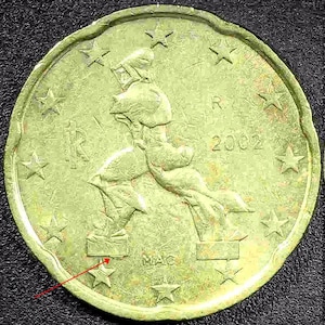May include: Two-sided 20 Euro Cent coin. The obverse features a running figure and stars, with the year 2002. The reverse shows a large number 20 and the words "EURO CENT". The coin is a light gold color.