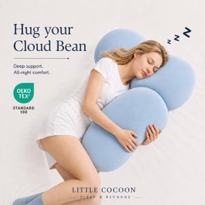 May include: A light blue, multi-sectioned body pillow with a soft texture. Text on the image reads: Hug your Cloud Bean, Deep support. All-night comfort., OEKO TEX STANDARD 100, LITTLE COCOON SLEEP & RECHAGE. The pillow is shaped to support the head and body.