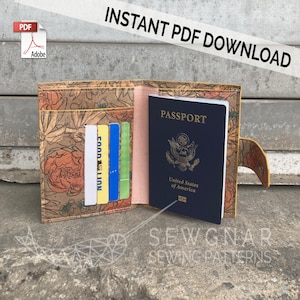 May include: A passport holder with a floral print design. The holder is open and a passport is visible inside. The passport is a US passport with the words "United States of America" printed on it. The holder has multiple card slots and a flap with a button closure.