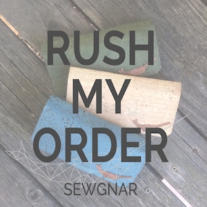 May include: Three cork wallets stacked on top of each other. The top wallet is green, the middle wallet is beige, and the bottom wallet is blue. The wallets have a speckled pattern and the words "Rush My Order" are printed in black on the wallets. The words "Sewgnar" are printed in black at the bottom of the image.