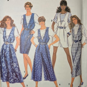 May include: A Simplicity sewing pattern envelope featuring illustrations of women's outfits. The outfits include dresses, jumpsuits, and a romper, all with a denim-like appearance. The envelope has the text "Simplicity" and "easy to sew".