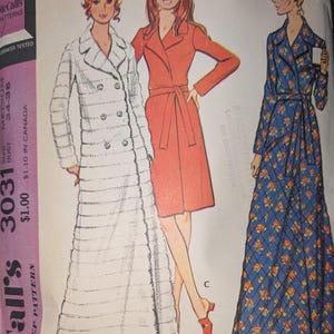 May include: A McCall's sewing pattern envelope for a robe, number 3031, size medium, 34-36 bust. The illustration shows three robe styles: a long white textured robe, a knee-length solid orange robe with a belt, and a long blue floral quilted robe.