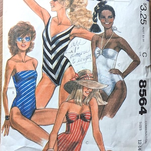 May include: A sewing pattern for three swimsuit styles. The pattern is for sizes 12-14-16. The swimsuits are black and white striped, white, and red and white striped. The pattern is from McCall's and is called "Cut-to-Fit".