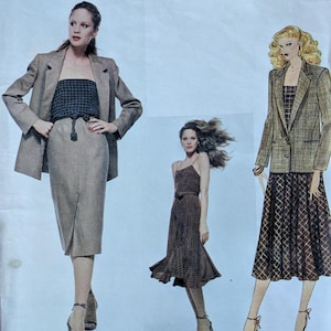 May include: A Vogue American Designer sewing pattern envelope for Calvin Klein, number 2140. The front displays illustrations of three outfits: a blazer with a tube top and skirt, a midi dress, and a blazer with a patterned skirt and top.