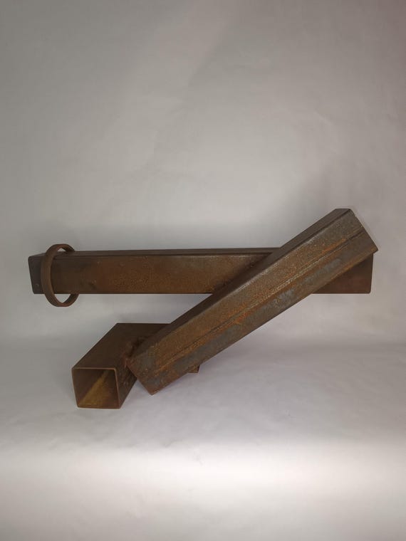 A hand-forged iron geometric sculpture that actually moves — balancing and swaying on your desk like a tiny piece of museum kinetic art.