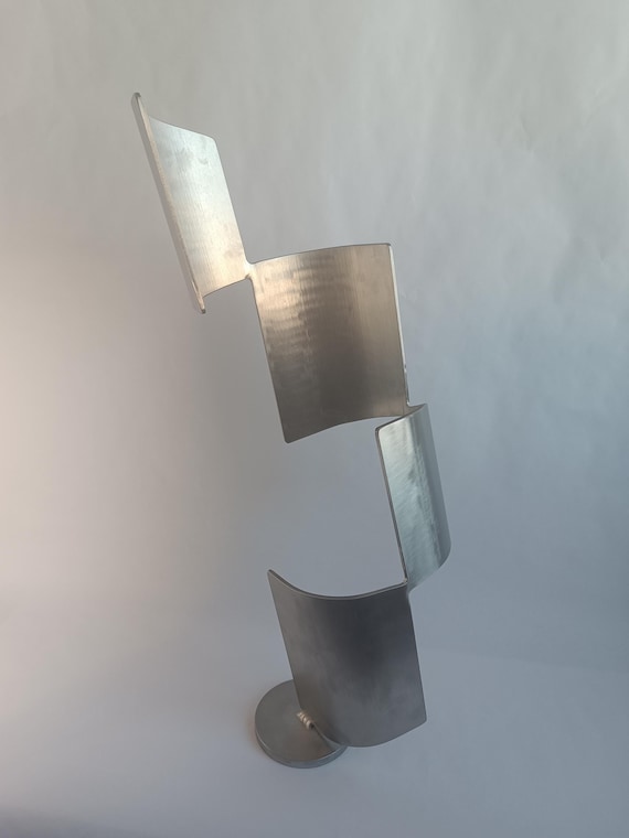 A handmade abstract steel sculpture called 'Twister' — at $430 this is serious contemporary art, and the form implies real welding craft and artistic intent.