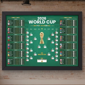 May include: A framed 2026 World Cup match schedule poster with a green background, featuring a central gold trophy illustration, group stage listings with national flags, and a tournament bracket layout for the upcoming soccer competition.