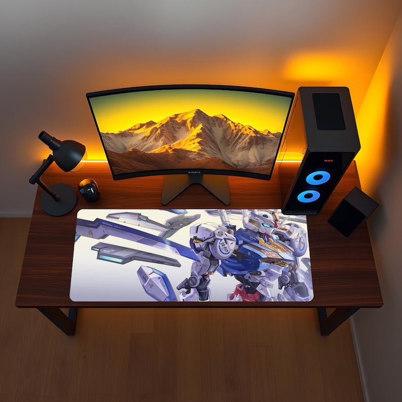 May include: A rectangular desk mat featuring a detailed illustration of a white, blue, and red robotic figure with mechanical components and sharp geometric shapes. The mat is positioned on a dark wood desk surface in front of a computer monitor.