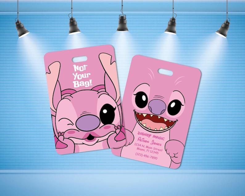 May include: Two rectangular pink luggage tags featuring a cartoon character with large eyes and a purple nose. One tag displays the text "Not Your Bag!" and the other shows "Disney Magic," a name, an address in Miami, FL, and a phone number.