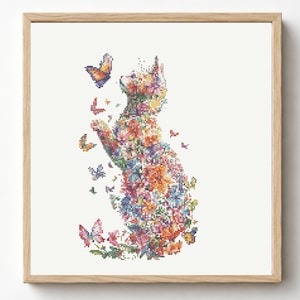 May include: A square framed cross-stitch embroidery featuring a cat silhouette composed of colourful floral patterns in shades of pink, orange, blue, and green. Several butterflies in various sizes and colours surround the cat, which is looking upward.