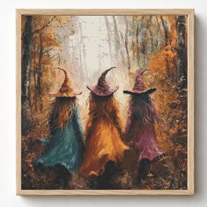 May include: A framed diamond painting depicting three figures wearing pointed hats and long cloaks in shades of teal, orange, and purple, walking away from the viewer into a dense, golden-toned autumn forest with tall trees and soft light.
