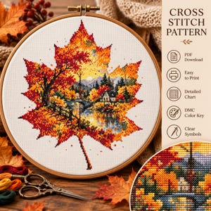May include: A cross stitch pattern in a wooden hoop featuring a large maple leaf filled with a landscape of a house, trees, and a lake in autumn colors. Text includes CROSS STITCH PATTERN, PDF Download, Easy to Print, Detailed Chart, DMC Color Key, and Clear Symbols.