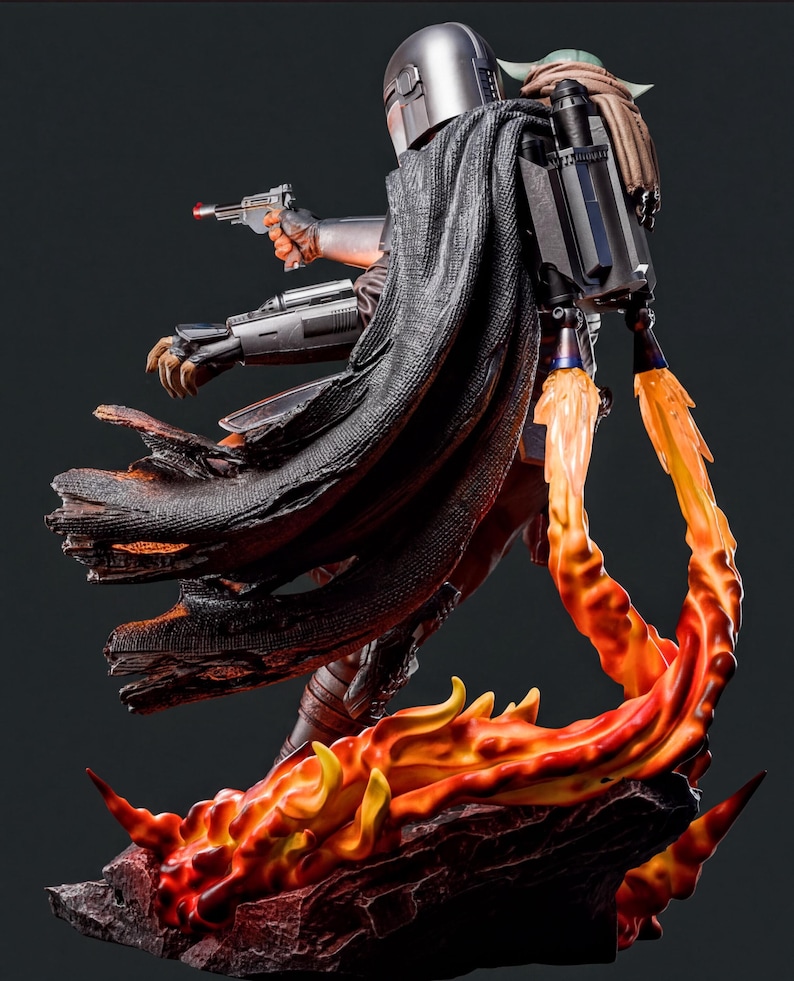 A detailed statue of a character from the Star Wars franchise, with a fiery background and a dynamic pose.