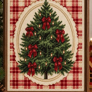 May include: A framed cross-stitch embroidery featuring a dark green Christmas tree decorated with small red bows and tiny white candles. The tree is centered within an oval border against a background of red and beige plaid fabric.