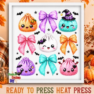 May include: A white sheet featuring a collection of glittery cartoon dumplings and bows. The dumplings have faces, some with hats, horns, or bats. The bows are purple, pink, and teal. Small black bats and stars are scattered throughout the design.