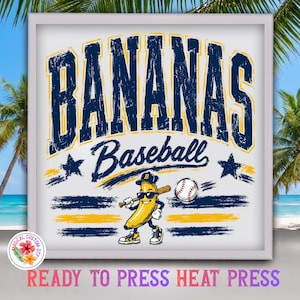 May include: A graphic print featuring the word BANANAS in large distressed navy blue letters with yellow outlines. Below, the word Baseball is written in script. A cartoon banana wearing sunglasses and a cap holds a baseball bat near a ball.
