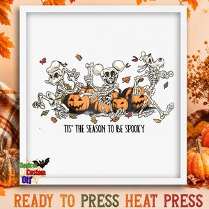 May include: A white square print featuring three cartoon character skeletons standing among orange jack-o'-lanterns and scattered autumn leaves. The text below the characters reads, "TIS' THE SEASON TO BE SPOOKY" in a simple black font.