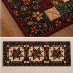 May include: A rectangular quilted table runner featuring three star-shaped patterns in shades of burgundy, forest green, and cream. The border is a dark fabric with a floral print of red berries and leaves, finished with a solid burgundy binding.