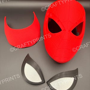May include: A bright red 3D printed mask with a textured web pattern, a separate red curved forehead piece, and two black eye lenses with white mesh inserts. The text CRAFTYPRINTS is visible multiple times across the image components.