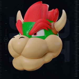 May include: A 3D printed bust of the character Bowser featuring a bright red spiked mane, a green textured shell-like head, tan snout, and curved horns. The design includes the text 2026, TEST PRINTED AMS COLORED STL, and YOSH STUDIOS.