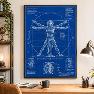 May include: A framed blue print poster featuring the Vitruvian Man in white line art. The design includes anatomical diagrams, geometric circles, squares, and technical text annotations detailing human body proportions and measurements in centimeters.