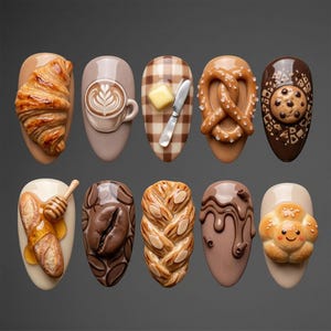 May include: A set of ten almond-shaped nail art tips featuring 3D food designs including a croissant, latte art, buttered toast, a salted pretzel, a chocolate chip cookie, a baguette with honey, coffee beans, braided bread, chocolate drizzle, and a bun.