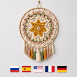 May include: A circular wall hanging featuring a central mustard yellow crocheted star surrounded by layers of cream, dusty pink, and sage green lace. The design is mounted on a bamboo hoop with hanging tassels in matching colors and wooden beads.