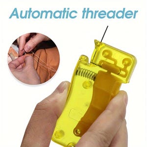 May include: A yellow translucent plastic automatic threader tool with a visible internal metal spring mechanism. The text Automatic threader is printed at the top. An inset circular image shows the tool being used to thread a needle with white thread.