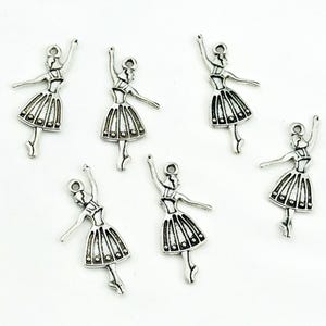 May include: Six silver ballerina charms with a detailed design. The charms are perfect for jewelry making, scrapbooking, and other craft projects.