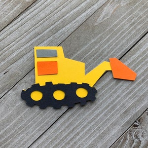 May include: A yellow toy construction vehicle with a black tread, orange and gray windows, and an orange scoop.