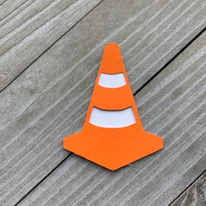 May include: Orange traffic cone cutout with white stripes. The cone is made of paper and is a simple design.
