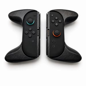 May include: A pair of black gaming controllers with ergonomic grips. The left controller features a teal-accented joystick and directional buttons. The right controller includes A, B, X, Y buttons, a home icon, a capture icon, and an orange-accented joystick.