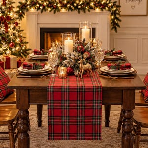 May include: A wooden dining table set for a holiday meal, featuring a red and green plaid table runner, matching plaid napkins on white plates, crystal glassware, a central floral centerpiece with candles, and four wooden chairs with plaid cushions.