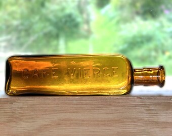 Antique Cafe Vierge triangular amber glass bottle.