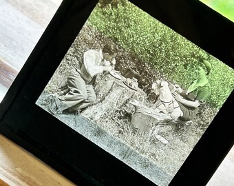 Lovely vintage glass slide, mother, son and little dog picnic. Circa 1930s.