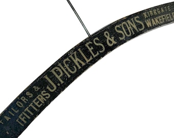 Vintage wooden tailor's hanger, branded J. Pickles & Sons. Black and gold.