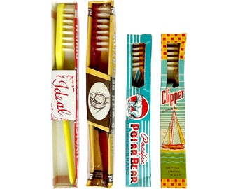 Vintage 1950s toothbrushes in original packaging, good condition, for packaging collector, display or as props, colourful graphics.