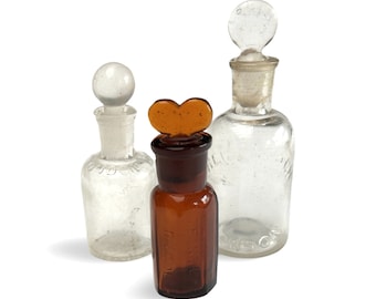 A collection of glass bottles with original stoppers. Collectable vintage glass.