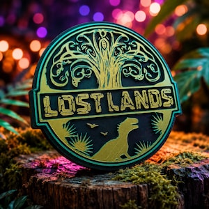 May include: A circular plaque featuring a gold-colored relief design on a black background. The top half displays a stylized tree, while the bottom half shows a dinosaur silhouette, palm leaves, and birds. The text LOST LANDS is centered.