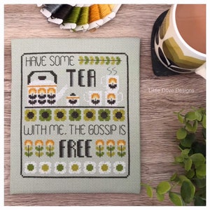 May include: Cross stitch pattern on green fabric with the text "Have some tea with me. The gossip is free." and a teapot, teacups, and flowers in a retro style.