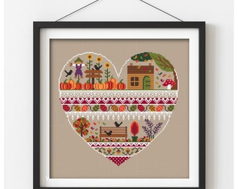 Peut inclure: Modèle de point de croix en forme de cœur avec un thème automnal. Le motif comprend une maison, des citrouilles, un épouvantail, des oiseaux et des feuilles. Le motif est encadré dans un cadre noir.