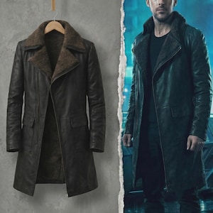 May include: A dark brown leather coat with a shearling collar and lining hangs on a wooden hanger. The coat has two front pockets and a classic, long design. A person is wearing a similar coat in the image.