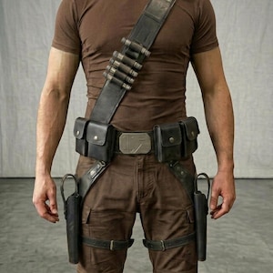 May include: A brown t-shirt and brown cargo pants worn with a black leather utility belt system. The gear includes a shoulder strap with five cylindrical loops, two waist pouches, a central metallic buckle, and two leg holsters.