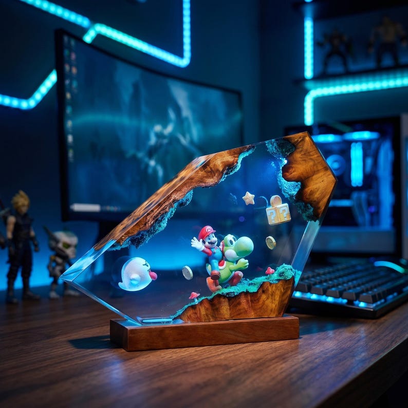 May include: A decorative resin and wood lamp featuring a miniature Mario riding Yoshi, a Boo ghost, a question mark block, a star, and coins. The scene is encased in clear resin with natural wood edges, illuminated by a blue light on a wooden base.