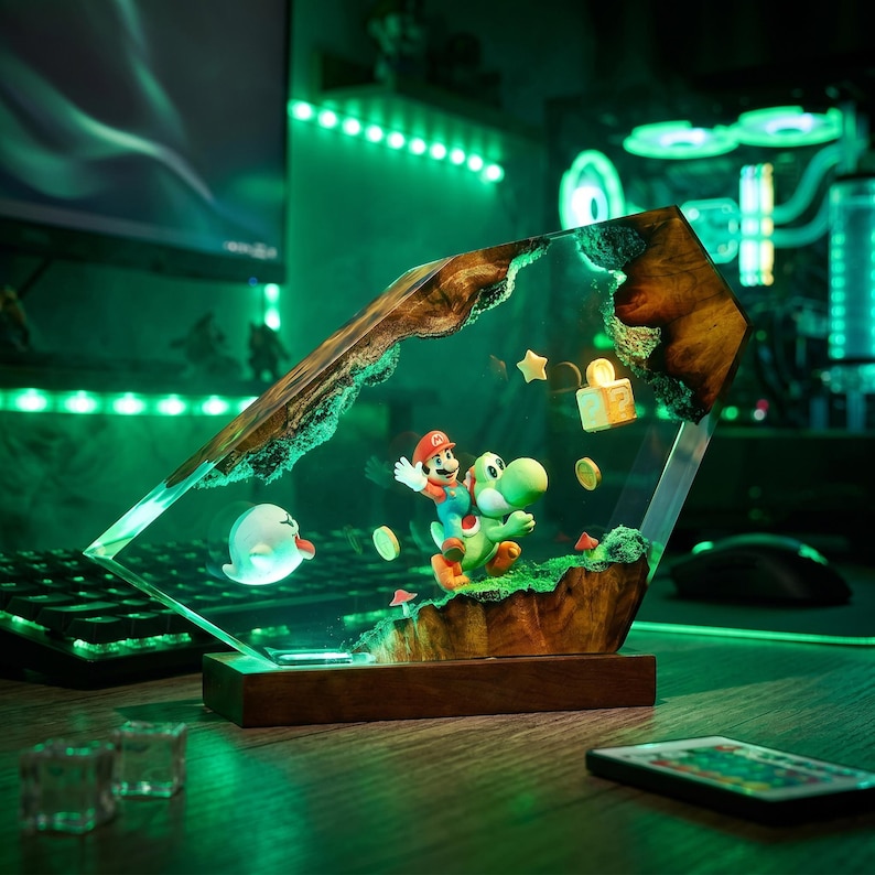 May include: A decorative resin and wood lamp featuring a miniature Mario riding Yoshi, a white Boo ghost, floating gold coins, a question mark block, and a small star. The scene is encased in a clear, angular resin block with natural wood edges.
