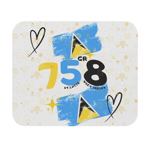 May include: A rectangular mouse pad featuring the number 758 in yellow, blue, and black. It includes the text ST. LUCIA WSET INDIES, two St. Lucia flag triangles, two black heart outlines, and yellow star accents on a light background with gold dots.
