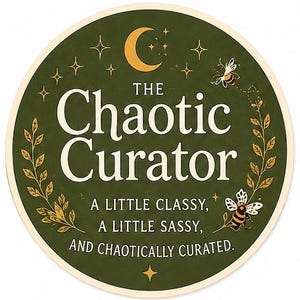 May include: A circular sticker with a dark green background featuring a gold crescent moon, stars, and two bees. The text reads: THE CHAOTIC CURATOR, A LITTLE CLASSY, A LITTLE SASSY, AND CHAOTICALLY CURATED. Two gold leafy branches frame the text on the sides.