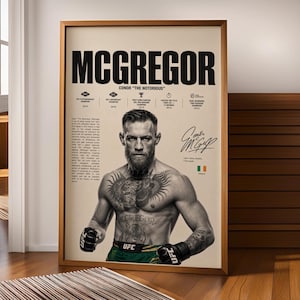 May include: A framed poster featuring a black and white portrait of Conor McGregor with the text MCGREGOR, his signature, and a list of his UFC achievements. The design includes a small Irish flag icon and descriptive text on a cream background.