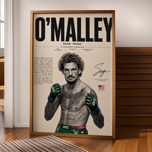May include: A framed poster featuring a black and white portrait of Sean O'Malley with curly hair, tattoos, and green UFC gloves. The text reads O'MALLEY, SEAN "SUGA", UFC BANTAMWEIGHT CHAMPION (2023), and includes a biography, a signature, and a US flag.