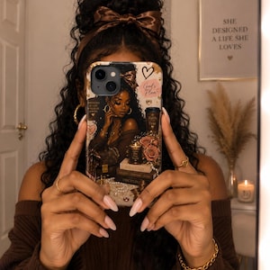 May include: A smartphone case featuring an illustration of a person with long dark curly hair, wearing a brown bow. The design includes a coffee cup labelled Faith Over Fear, stacked books labelled Boss Lady and Discipline, a candle, and text reading God's Plan.